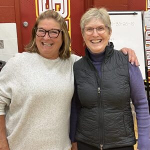 Former physed teachers Stephanie Walker and Lisa Sellon cheer their Gryphons.