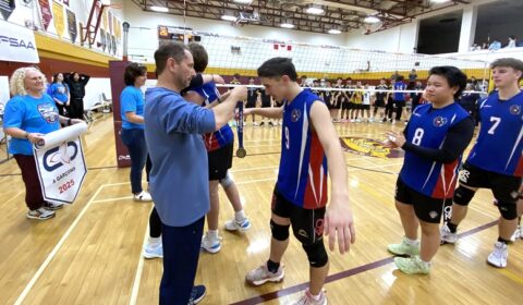 The gold and silver teams both received medals from their coaches.