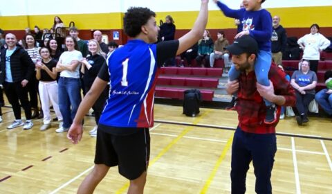 Aziz Alssi, 17, gets high-five from his jubilant cousins Zeyden Grati, 3, after the game.