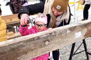 Elsie Hilgartner, 4, gets help from mom Laura. Elsie Hilgartner, 4, gets help from mom Laura.